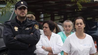 armed guard and medics outside Carols III hospital in Madrid