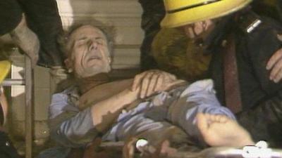 Norman Tebbit being removed from rubble