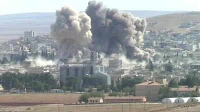 two smoke plumes rise above Kobane, Syria