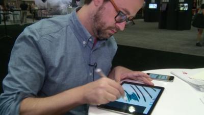 A man drawing using a tablet