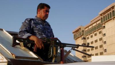 Member of peshmerga unit carrying gun