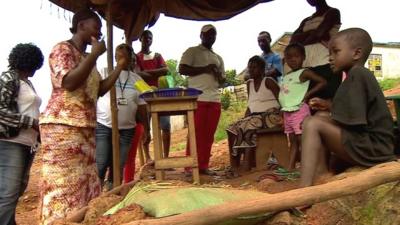 Women in Sierra Leone teaching villagers about Ebola