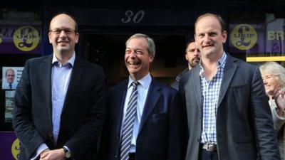 Ukip leader Nigel Farage (centre) and newly elected Ukip MP Douglas Carswell (right) joins their party"s candidate Mark Reckless on Rochester High Street