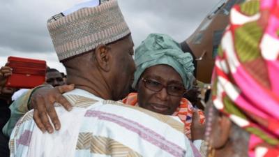 Cameroon's Deputy Prime Minister Amadou Ali (L) greets his wife Akaoua Babiana