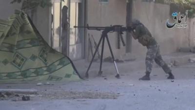 Still from IS video showing man with gun in Kobane