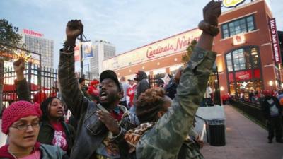 Inspired by the August 9 death of Michael Brown in Ferguson, Missouri, demonstrators protest against racial injustice outside Busch Stadium before the start of the National League Championship Series (NLCS) between the St. Louis Cardinals