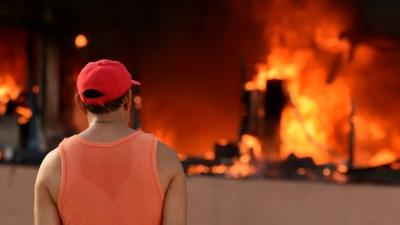 A man stares at the blazing Municipal Palace in Chilpancingo