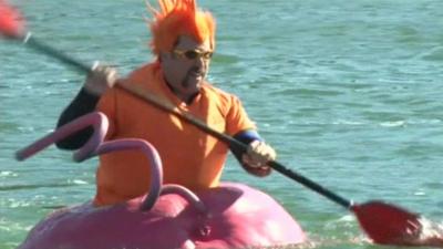 A man swimming in a giant pumpkin