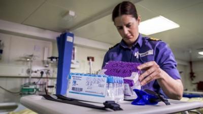 Royal Navy nurse Lieutenant Susan Jeffreys checks medical equipment aboard the Royal Fleet Auxiliary Argus