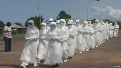 Group of health workers in Freetown, Sierra Leone, wearing protective suits during training