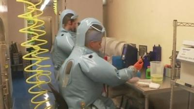 Lab workers in protective clothing