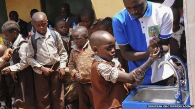 Nigerian pupils of Powa International Childrens School wash their hands as part of the 2014 Hand Washing Day Ebola sensitization campaign in Abuja, Nigeria