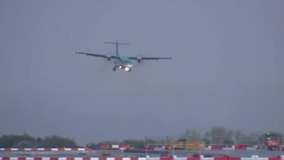 Plane landing at Manchester Airport in stormy weather