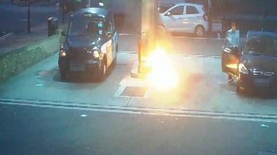 CCTV still of suspect starting fire at petrol garage in Greenwich