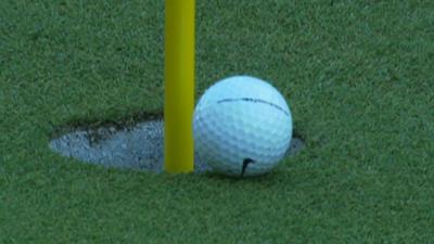 Tiger Woods chips the ball into the hole on the 16th at Augusta