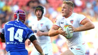 England's Tom Burgess runs against Samoa