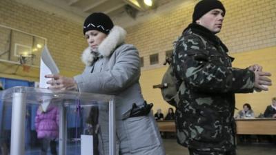 Ukrainian voters cast their ballots at a polling station during parliamentary elections in Kiev