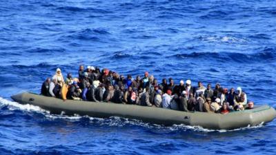 African migrants in a rubber boat off the coast of Italy