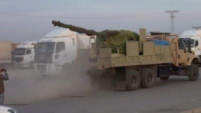 Truck carrying a large artillery gun