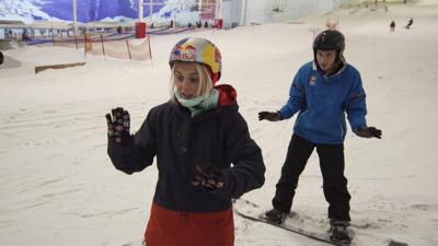 Aimee Fuller gives BBC Radio 1Xtra DJ Nick Bright a snowboarding lesson