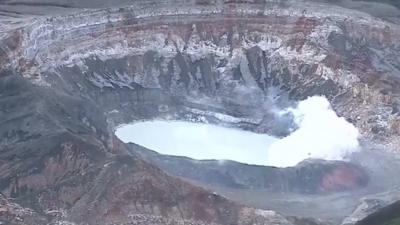 Ash erupting from the crater of the volcano