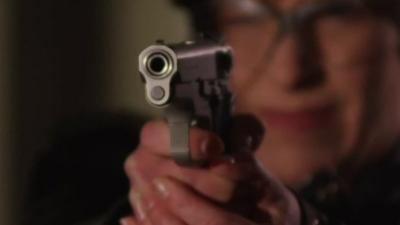 Joni Ernst holds a pistol in a campaign advert.