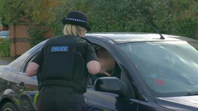 police officer talks to motorist