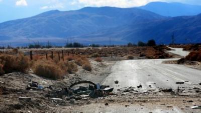 Debris from SpaceShipTwo lies on the desert field and road on November 1, 2014, in Mojave, California