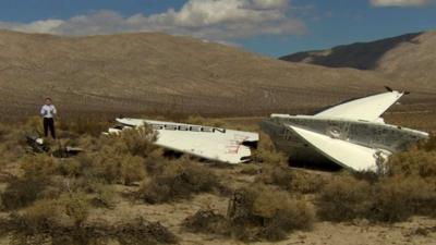 David Willis stands beside wreckage of Virgin Galactic SpaceShipTwo in Mojave desert