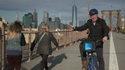 John Maguire on a bike on Brooklyn Bridge