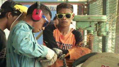 Young boys working with metal