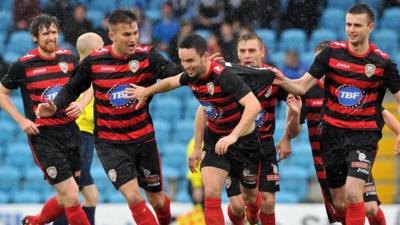 Coleraine players celebrate taking the lead against Ballymena