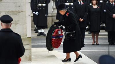 The Queen lays down a wreath