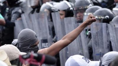 Protesters and riot police