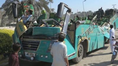 A Pakistani passenger bus with its roof ripped off the main body is pictured after the accident in Khairpur