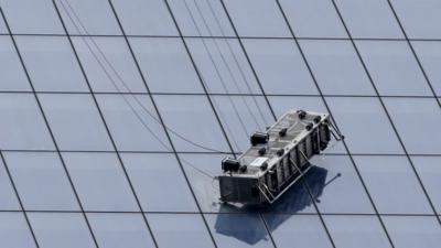 A partially collapsed scaffolding hangs from the One World Trade Center in New York