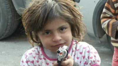 Child with toy gun