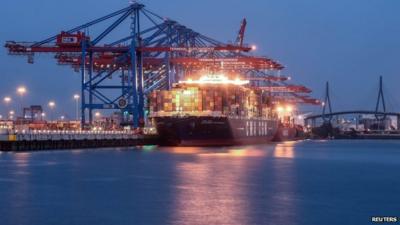 Containers are loaded onto a container ship in Hamburg, Germany