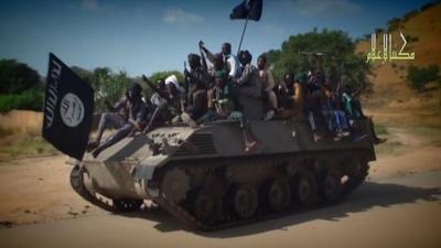 A screengrab taken on November 9, 2014 from a Boko Haram video released by the Nigerian Islamist extremist group Boko Haram and obtained by AFP shows Boko Haram fighters parading on a tank in an unidentified town
