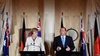 Australian Prime Minister Tony Abbott (R) and German Chancellor Angela Merkel answer questions during a joint press conference at Admiralty House in Sydney, Australia