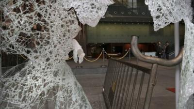 A broken glass is seen after protesters broke at the Legislative Council in Hong Kong Wednesday, Nov. 19, 2014