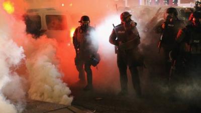 Police guard the Ferguson police department