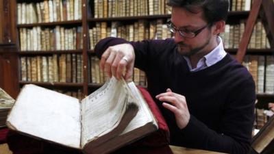 Remy Cordonnier, the director of the Saint-Omer library’s medieval and early modern collection, opens a page of the newly discovered Shakespeare"s original first folio.