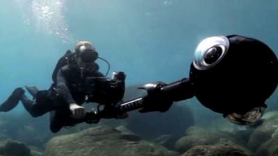 Diver with a camera mapping the ocean floor