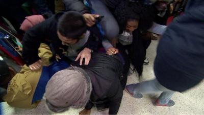 Shoppers in Wembley falling over each other as they rush to buy merchandise on 'Black Friday'