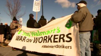 Protesters hold a "War on Workers" banner during the Black Friday strike