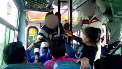 A girl kicks a man on a bus in India