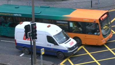 Cardiff bus and van at yellow box junction in the city centre