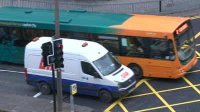 Cardiff bus and van at yellow box junction in the city centre