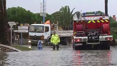 Emergency vehicles in flooded street in French town of Saint-Cyprien